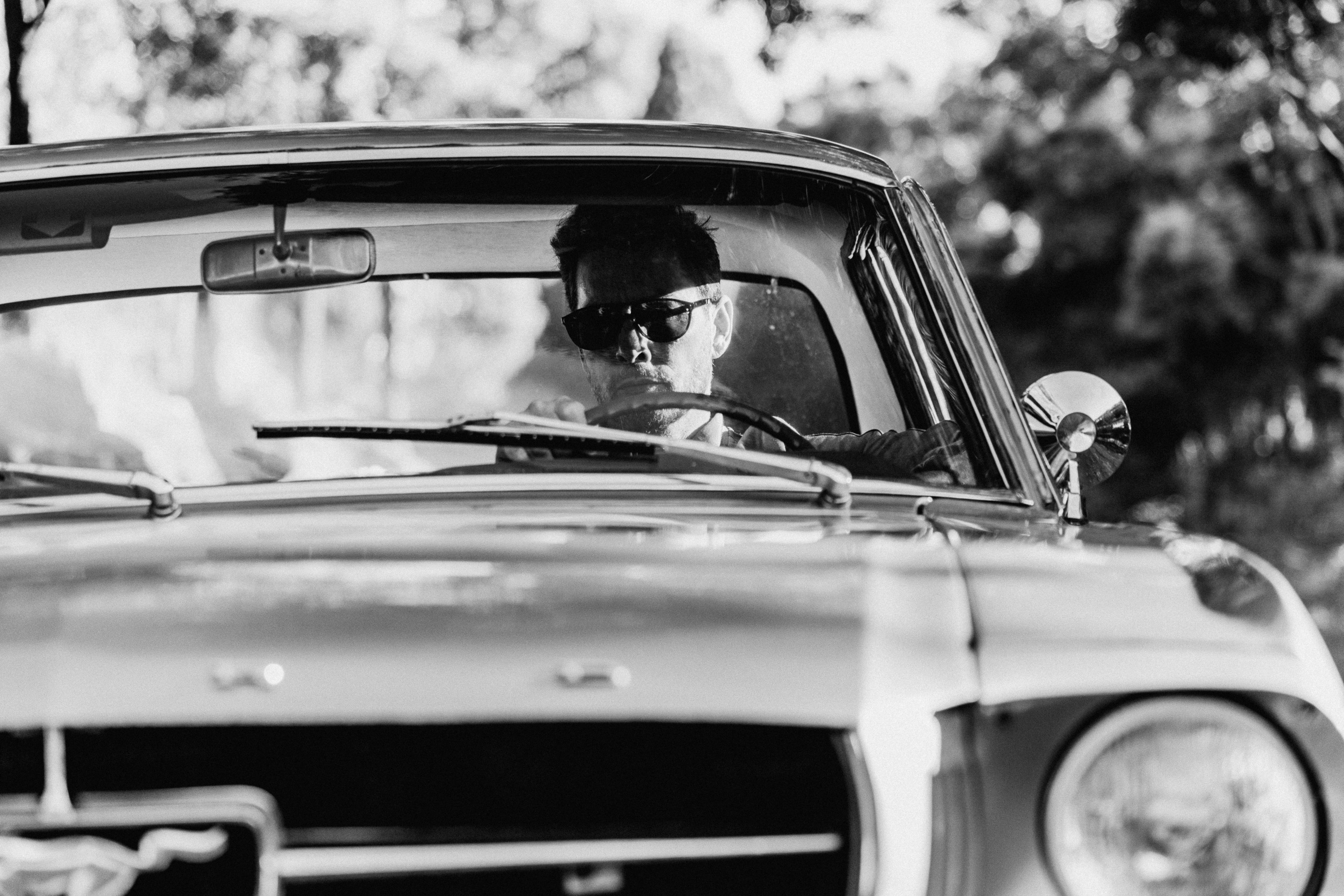 Old Mustang with cool guy wearing sunglasses in retro design